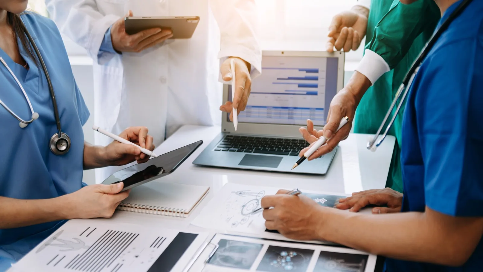 Medical professional reviewing patient information on a secure tablet at a clinic