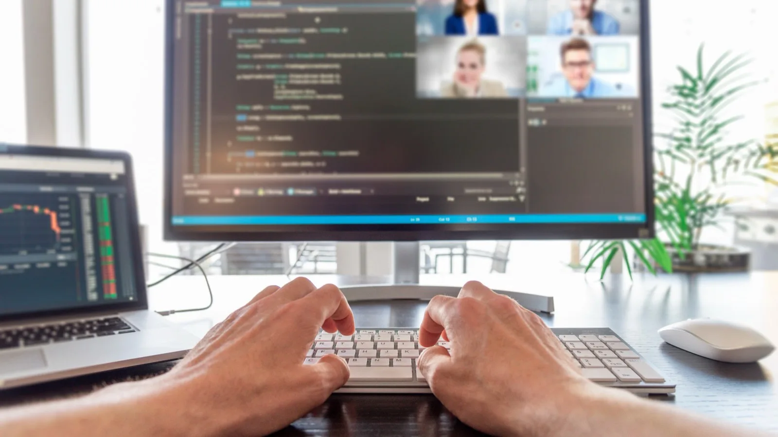 Developer coding while in video conference with distributed nearshore team members