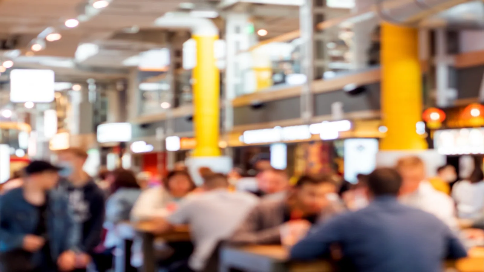 Busy food court at a US shopping mall, people choosing where to eat