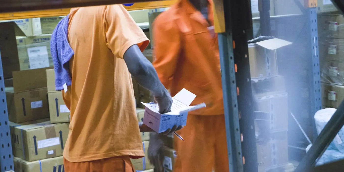 A worker handling packages inside a warehouse