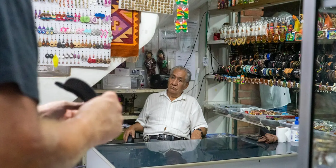 El dueño de una tienda detrás del mostrador, entre la mercadería