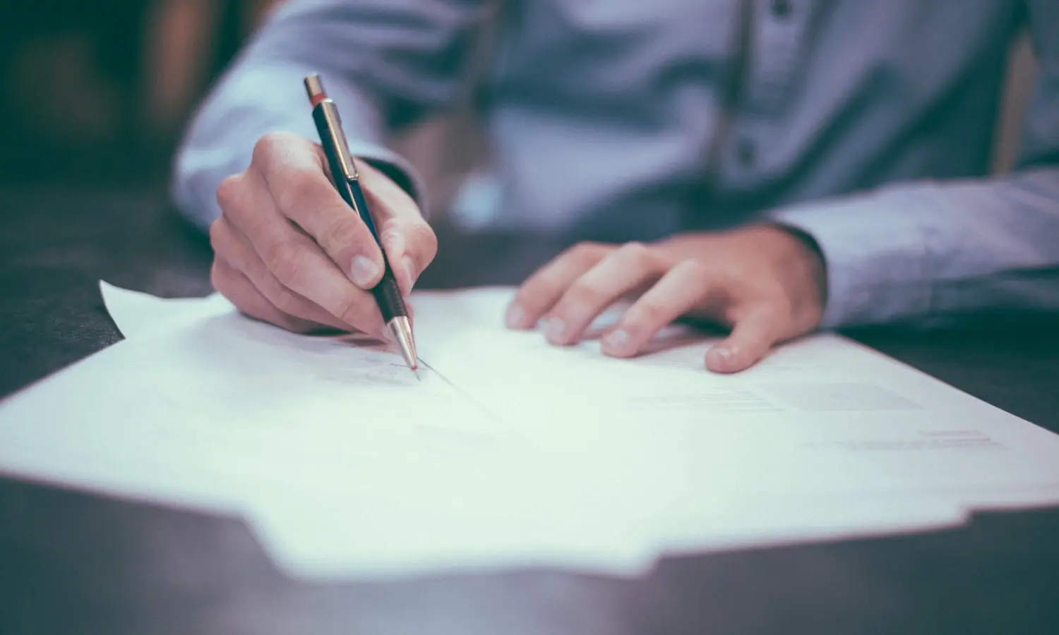 Filling in a form by hand, which is where the security questionnaire ends up