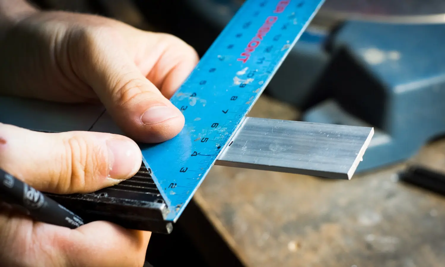 A machinist measuring a part against spec on the shop floor
