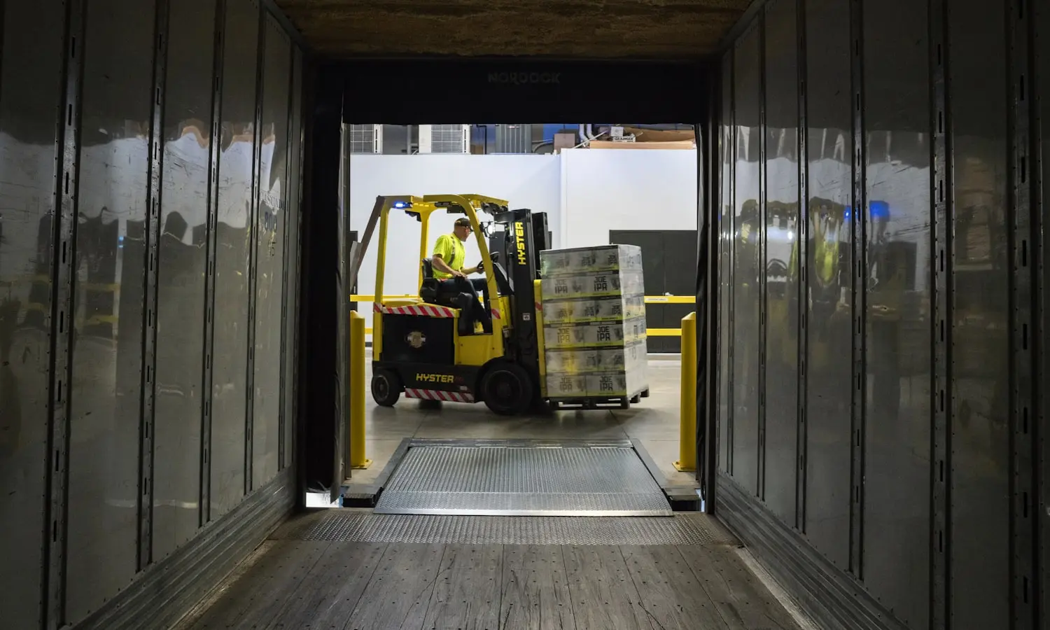 A forklift working inside a trailer at a distribution centre