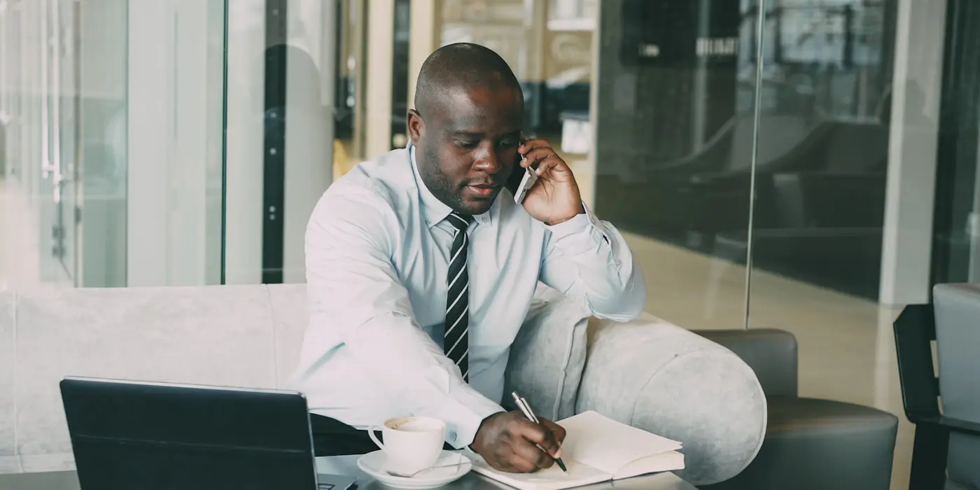 Taking notes by hand during a client call, which is where the CRM starts