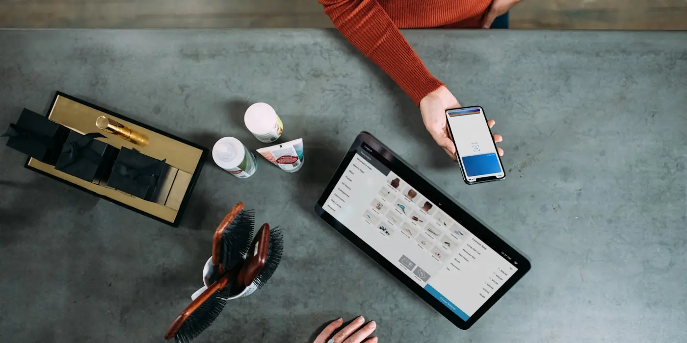 An online store open on a tablet next to a phone